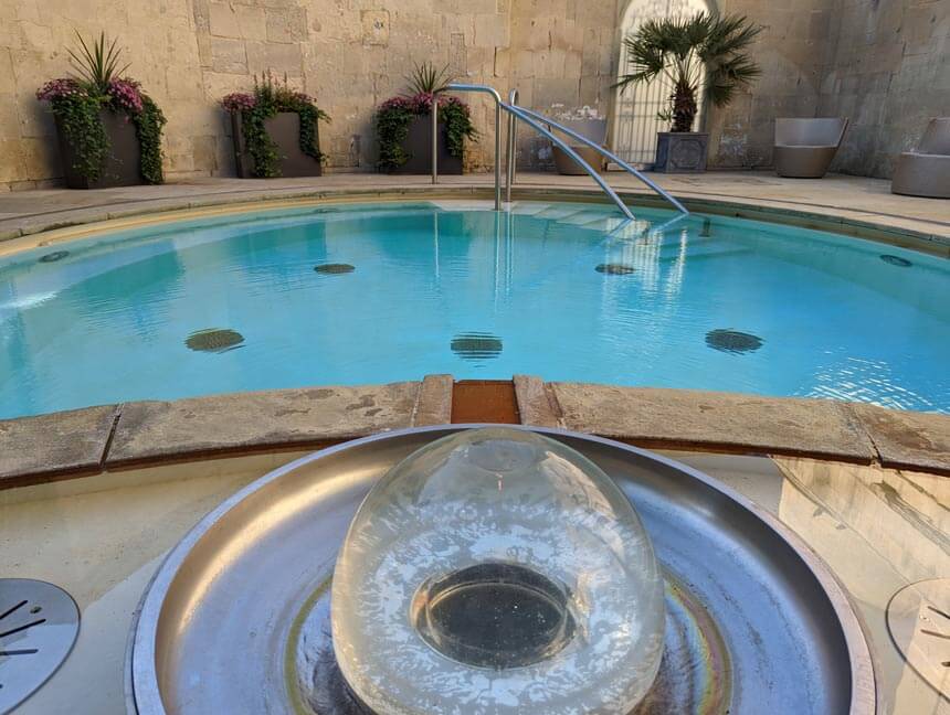 The warm waters of the Cross Spring bubble up through this fountain inside the historic Cross Bath. The Cross Spring is one of three hot springs that supply Thermae Bath Spa.