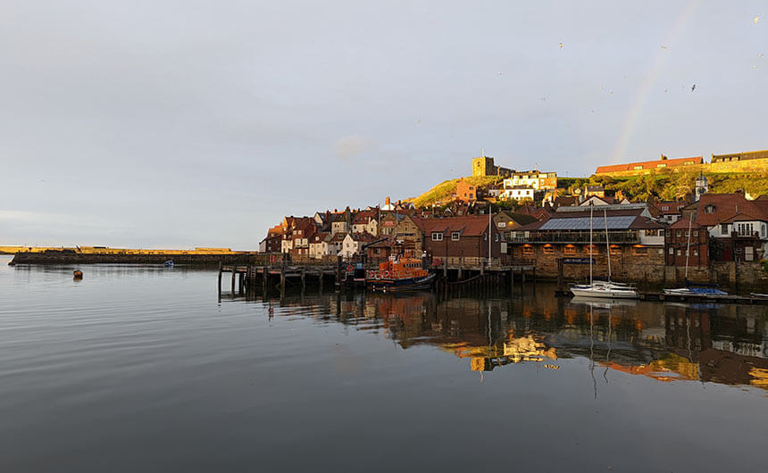 The old part of Whitby at sunset with St Mary's church on top of the hill.