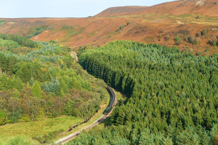 A North Yorkshire Moors Railway steam train snaking through the gorgeous countryside between Whitby and Pickering