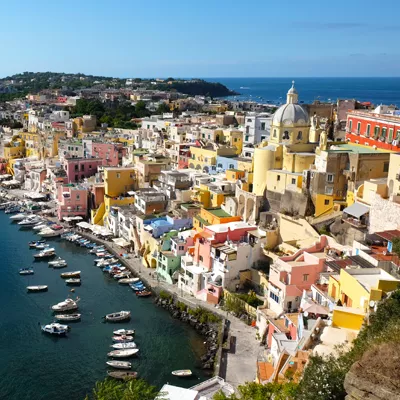 Colorful houses and boats along the waterfront in Procida, Italy