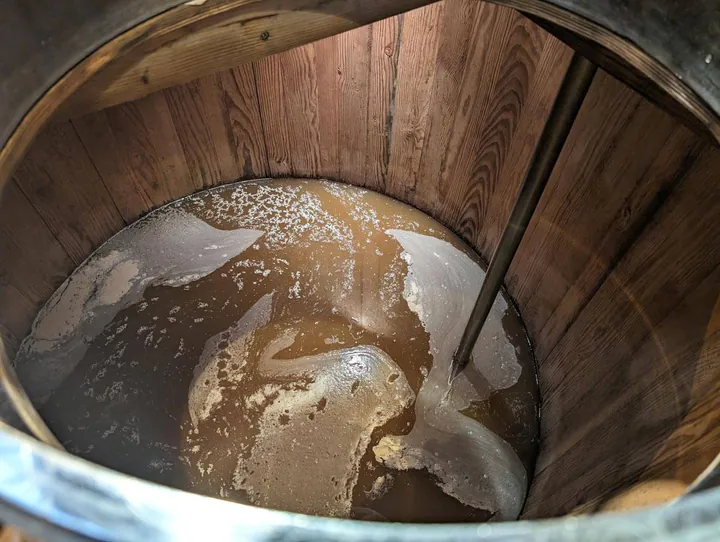 Looking down into one of the washbacks and the yeasty liquid inside