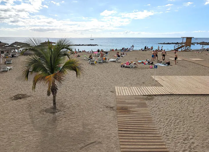 Playa del Duque beach. A golden sandy beach with blue sea beyond.
