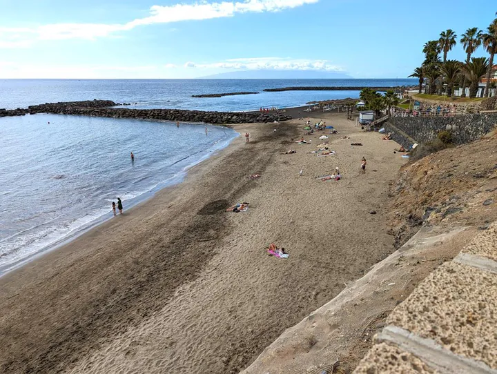 Playa del Duque in Costa Adeje. The golden sands of the southern part of the beach turn black and volcanic in the northern section.