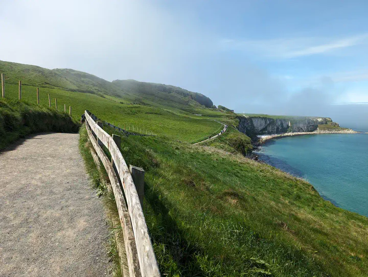 A wide gravelly path along a cliff above the sea