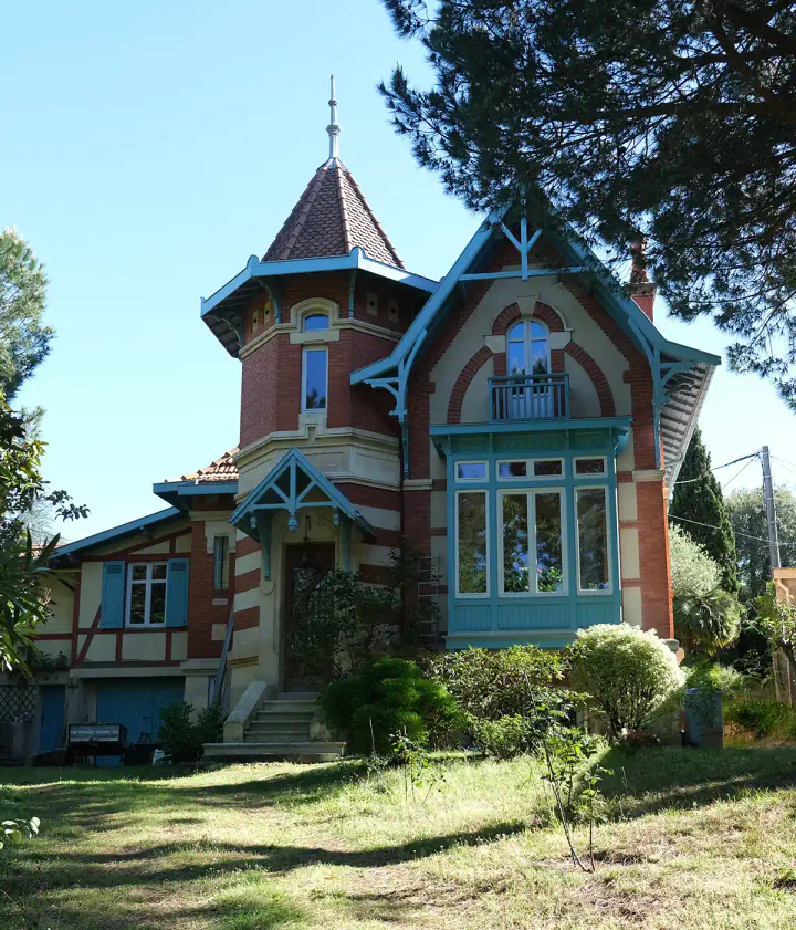 A romantic villa with a turret and ornate windows