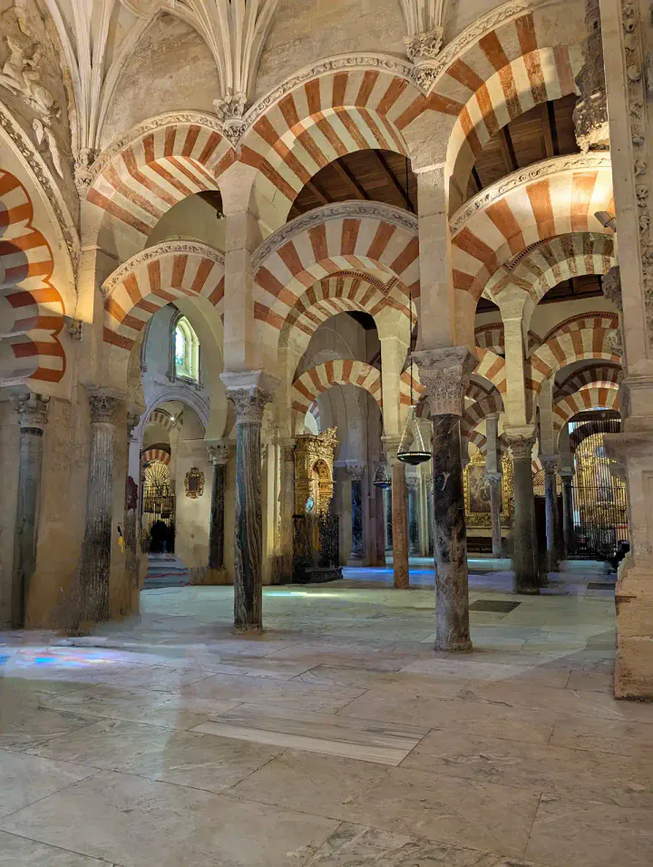 A forest of red and white striped arches in the Mezquita-Cathedral in Córdoba.