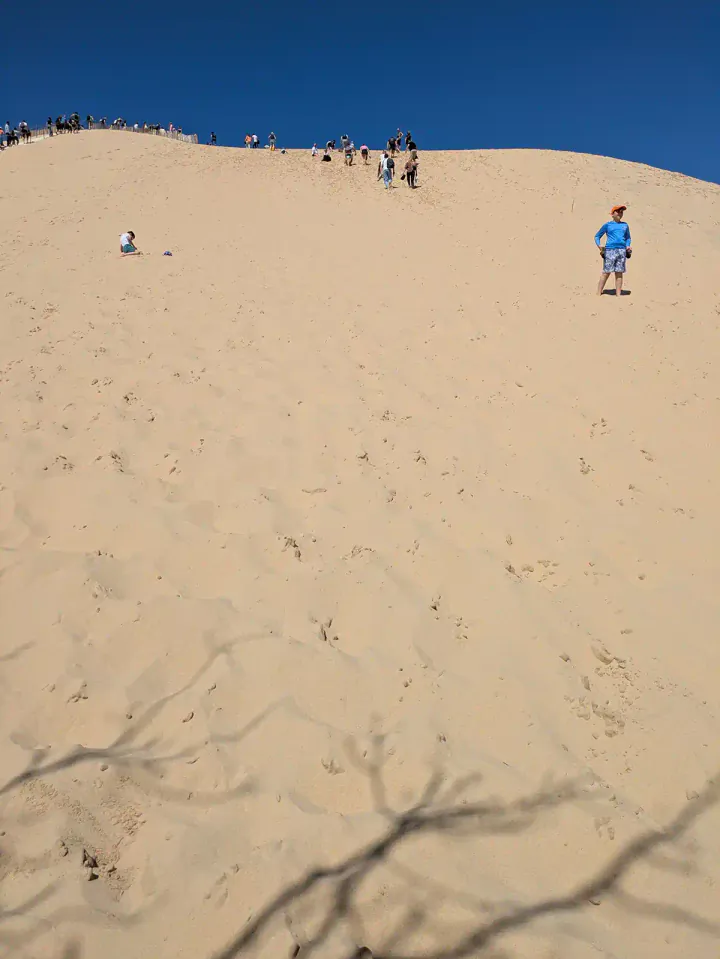 Standing at the bottom of an enormous sand dune