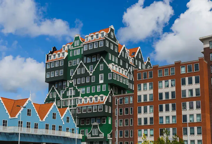 A big building which looks like lots of colourful traditional Dutch houses on top of each other