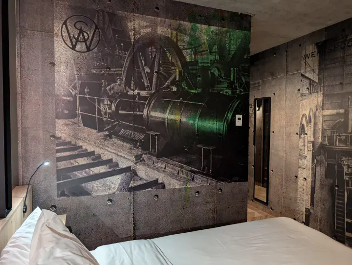 An old photograph of a steam engine, blown up and used as wall decor in a hotel