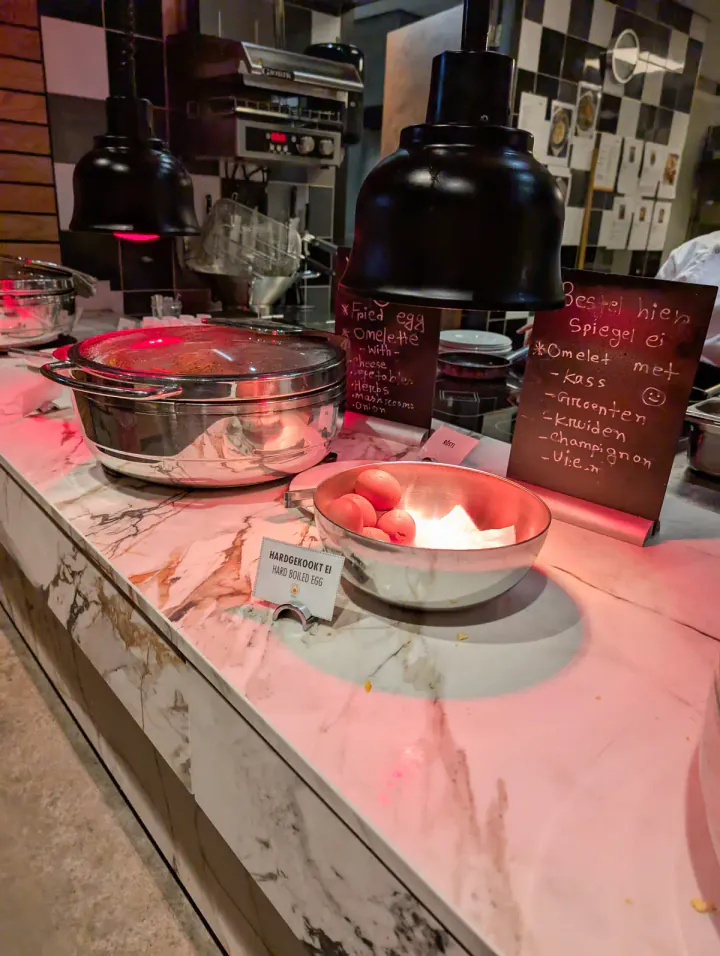 A hot food selection at a hotel breakfast buffet