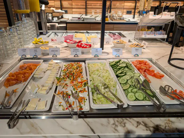 A chilled selection of cheese, vegetables and other cold foods a breakfast buffet