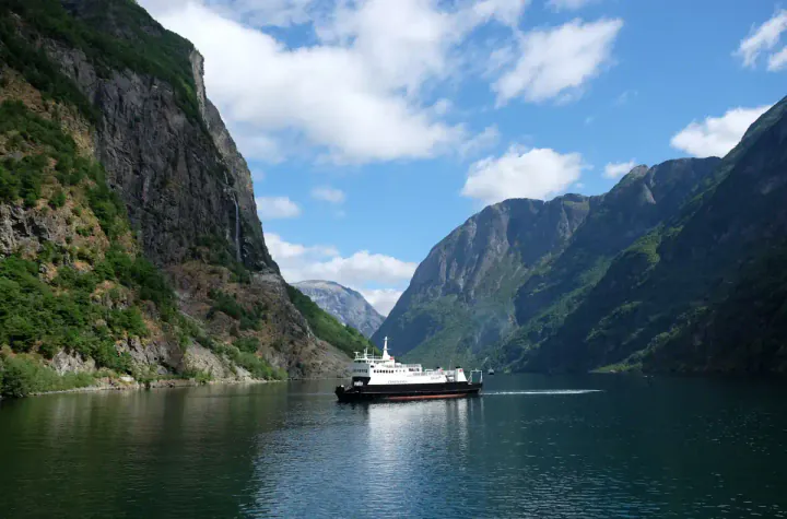 A ship in a beautiful fjord on a sunny day
