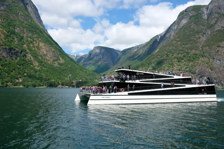 A futuristic electric boat in a fjord