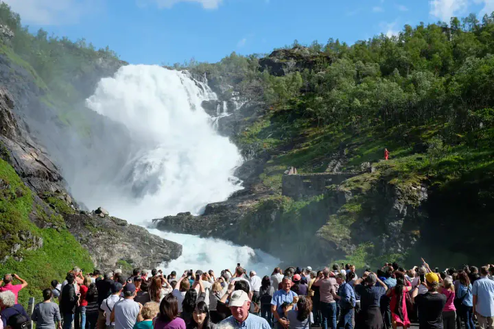 A huge waterfall with a crowd in front of it