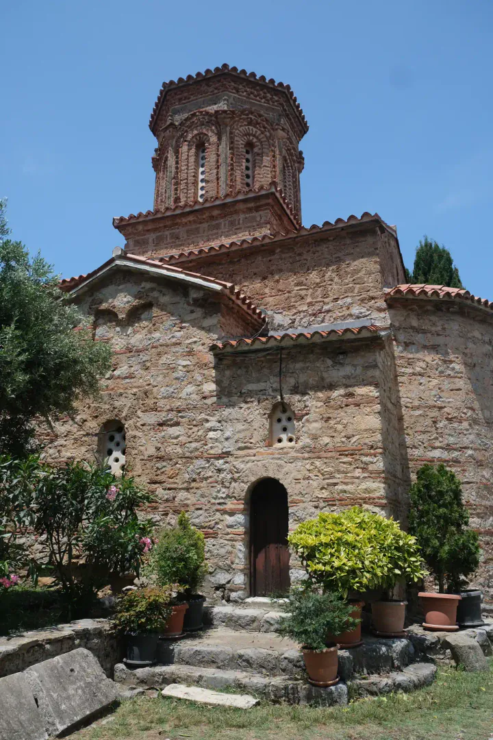 The church at St Naum. An old Byzantine church with plants and flowers around the outside.