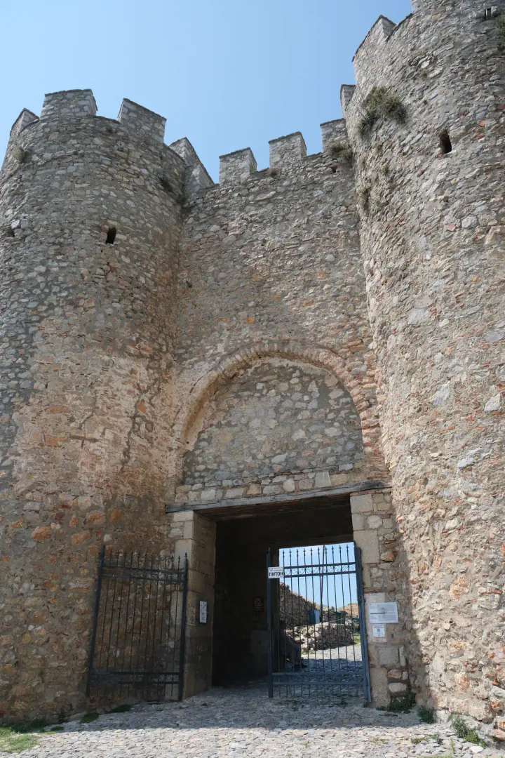 A castle gate with high stone towers on either side.