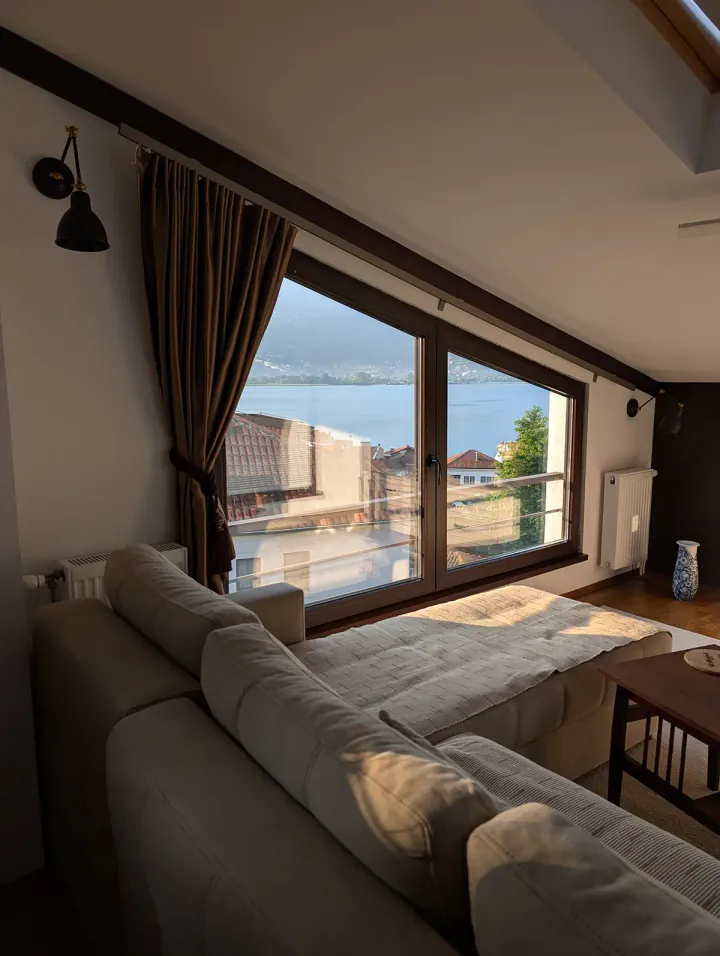 A sofa with a view of the lake