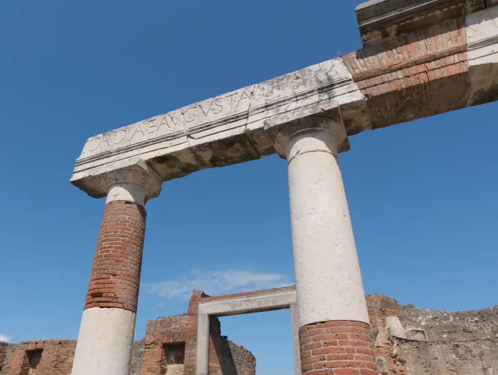 Latin letters carved into the top of a ruined architrave