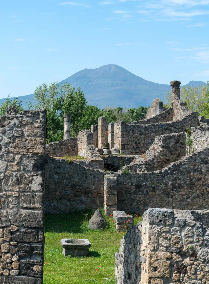 Ruined houses at Pompeii, with Mount Vesuvius in the background