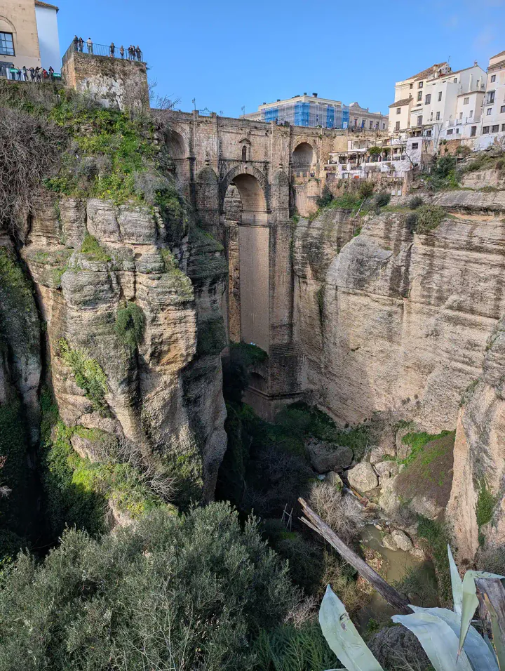 The Puente Nuevo in Ronda, one of the best day trips from Malaga. A towering old stone bridge crosses a narrow but very deep gorge.