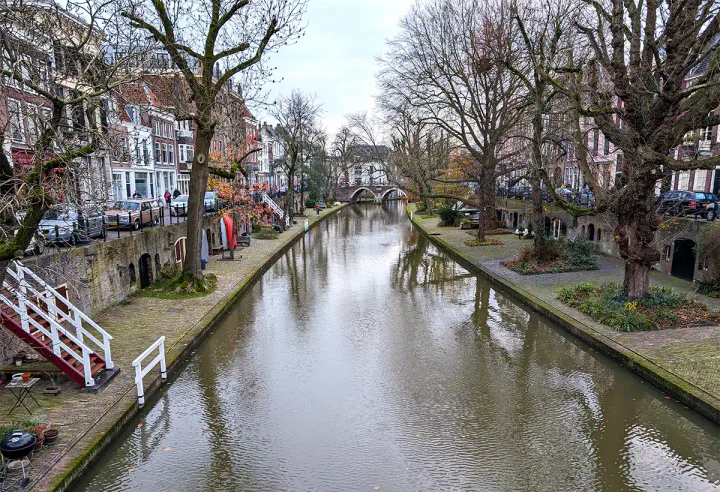 A canal in Utrecht. The street and canalside houses are at a higher level than the canal and wharves