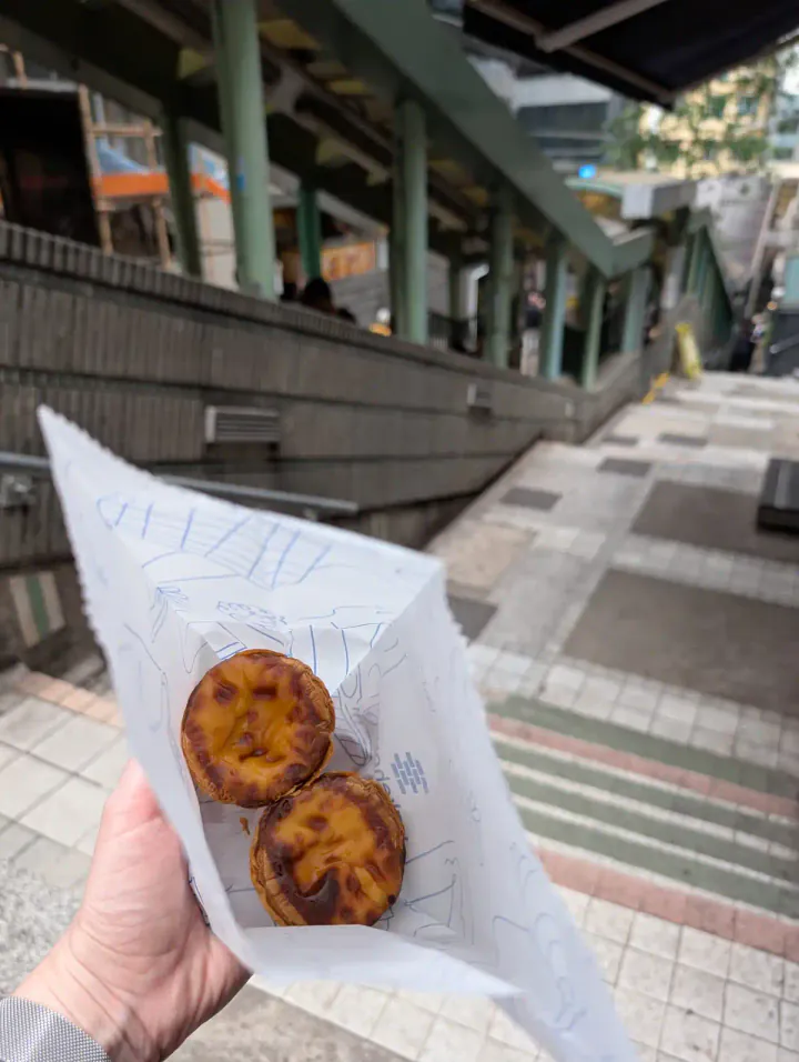 Custard tarts in a bag, next to the Central-Mid-Levels Escalators