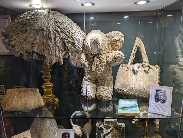 Items that have been turned to stone by the waters of the Petrifying Well, including a handbag which once belonged to Agatha Christie