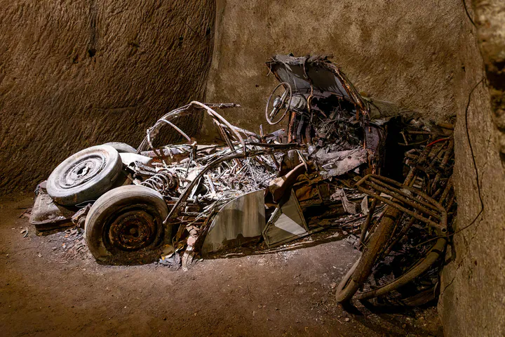 The skeletal remains of an old car that has almost completely rotted away