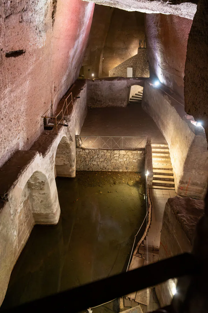 A series of water chambers with stairs connecting them. Some still have water still in them.