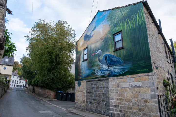 A large mural of a heron covering the side of a house in Knaresborough