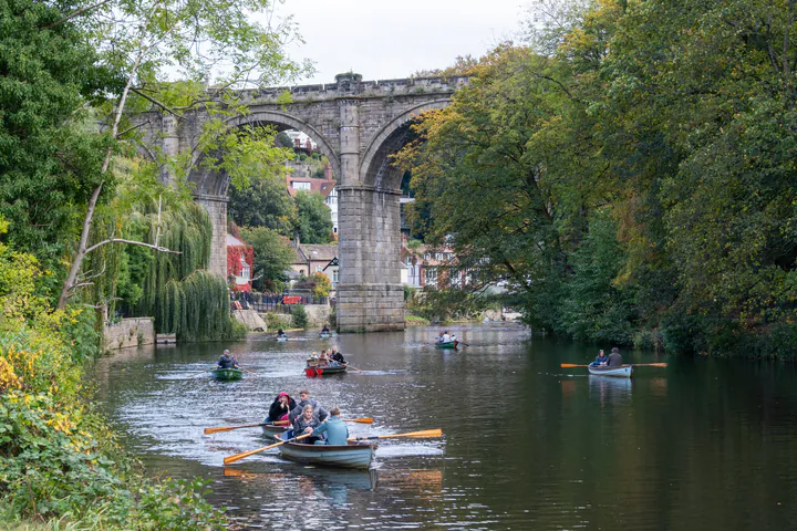 Rowing boats on the River Nidd underneath the railway viaduct