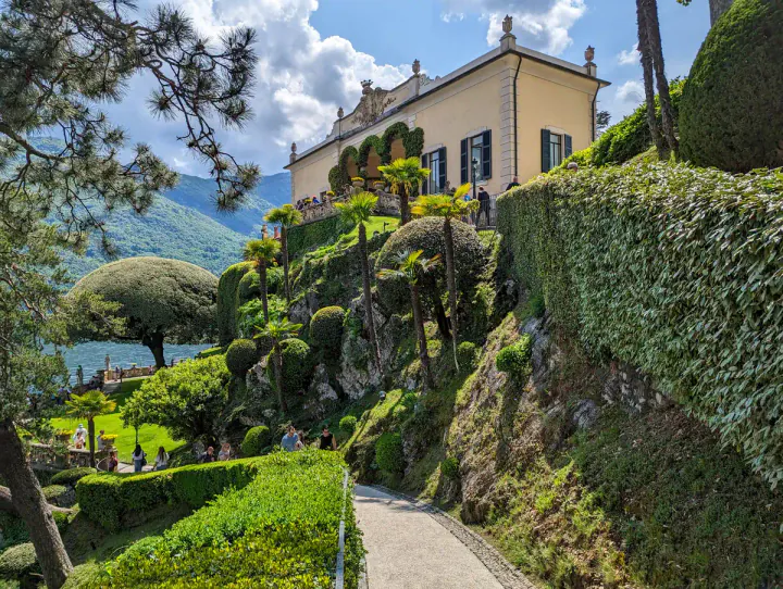 A grand yellow house in beautiful gardens