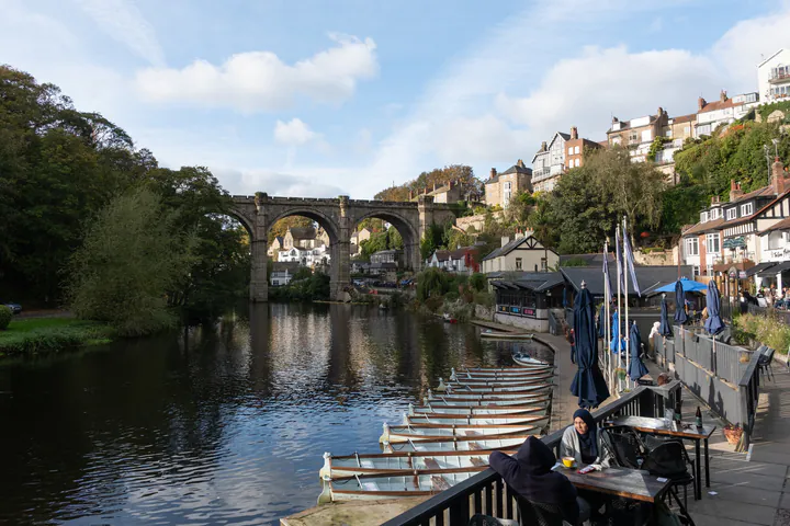 A view from a riverside cafe with the viaduct and boats for rent