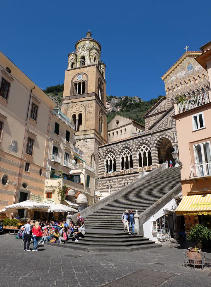 A square with a large church. There's a big flight of stairs up to the entrance of the church.