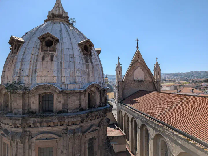 A little dome just peeking out between the roofs of the Duomo
