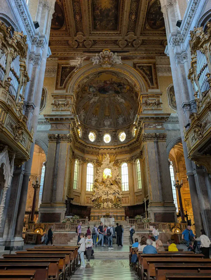 The inside of a large, grand Catholic church with lots of decoration