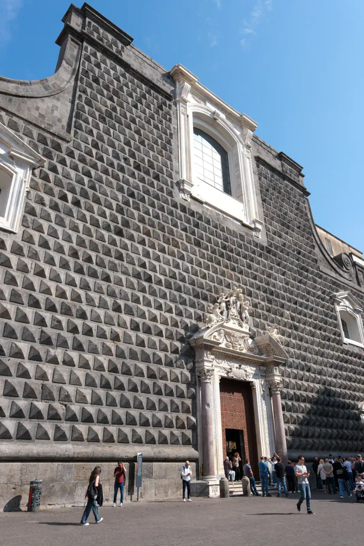 A grey stone church with textured, geometric walls