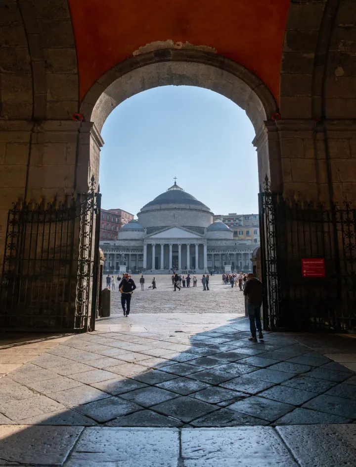A large, domed church seen through an arch