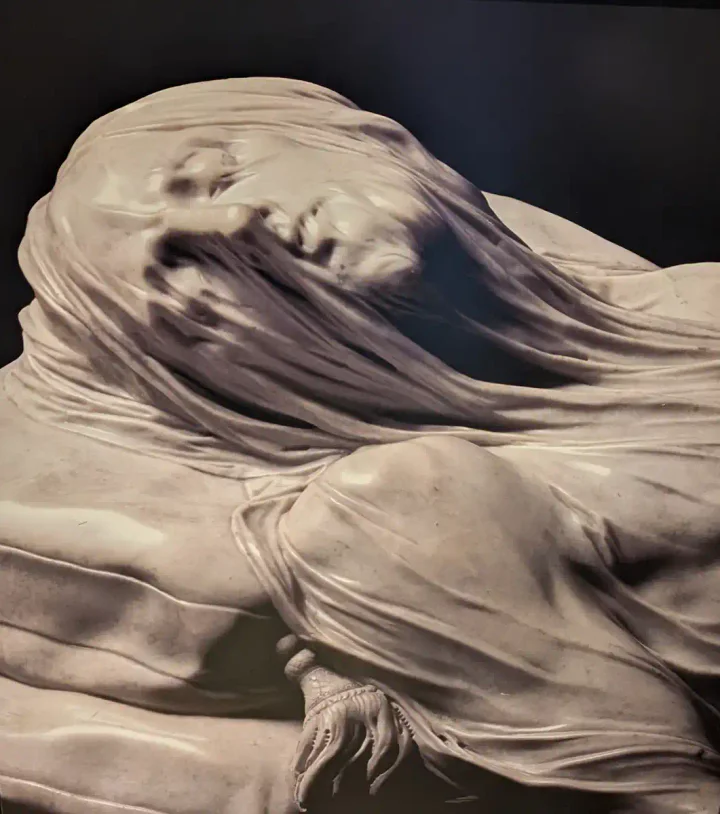 A photo of a poster of the Veiled Christ at Sansevero chapel
