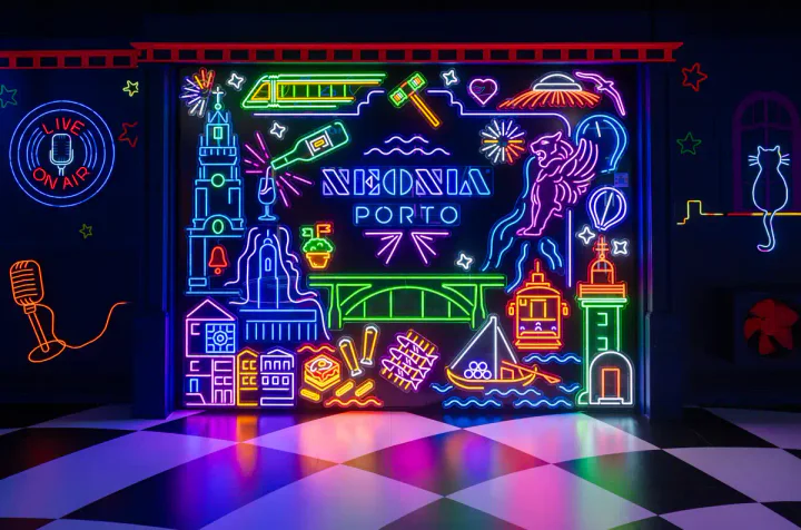 A neon sign at Neonia Porto, showing lots of symbols of the city, including trams, port wine, Clérigos tower and the lighthouse at Foz