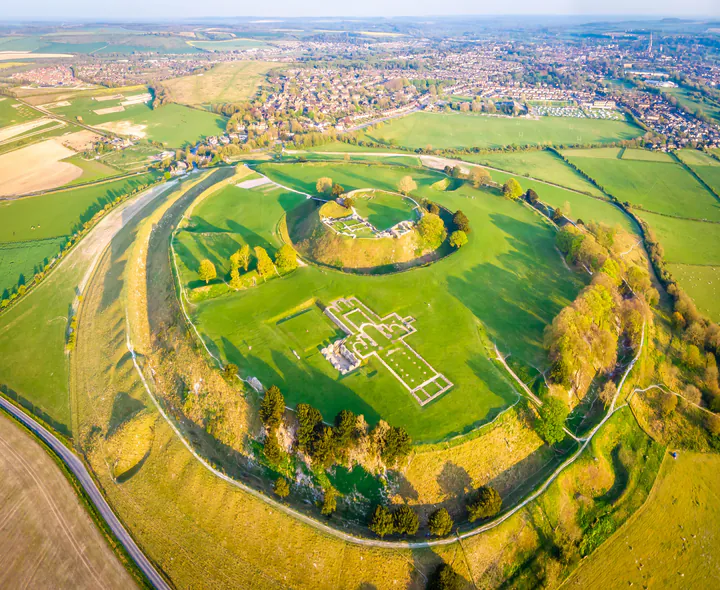 An aerial photo of Old Sarum, showing the huge earthworks and the outline of the old cathedral