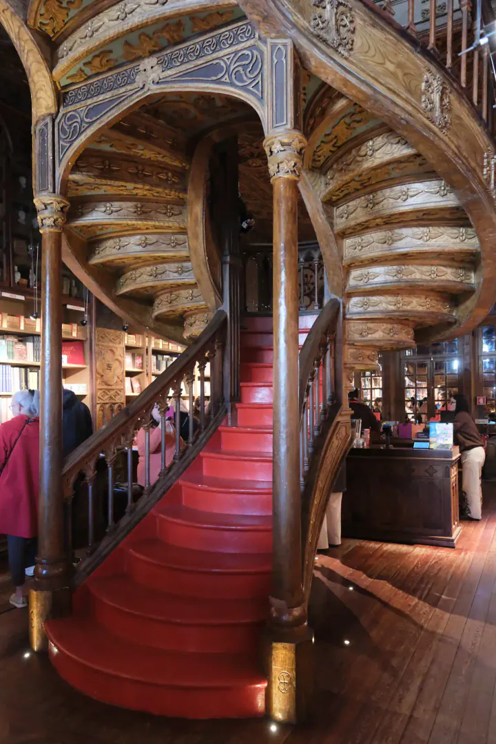 A sweeping red staircase at Livraria Lello, Porto's famous bookshop