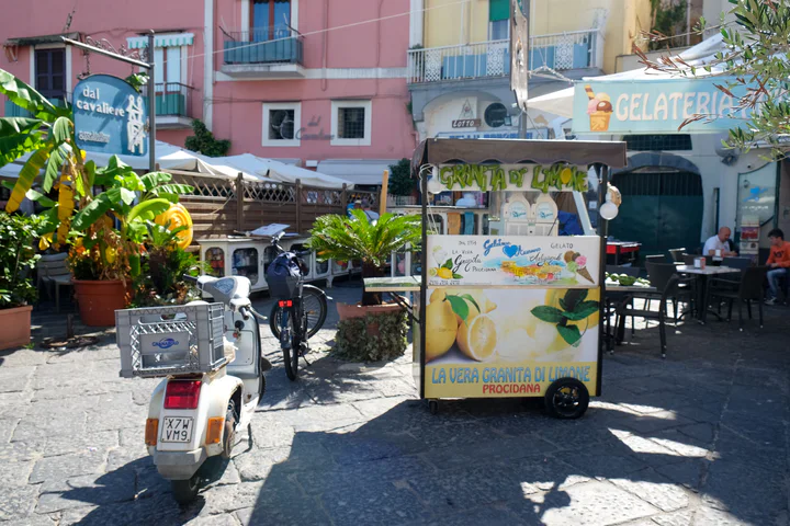 A lemon granita stand in front of a gelateria