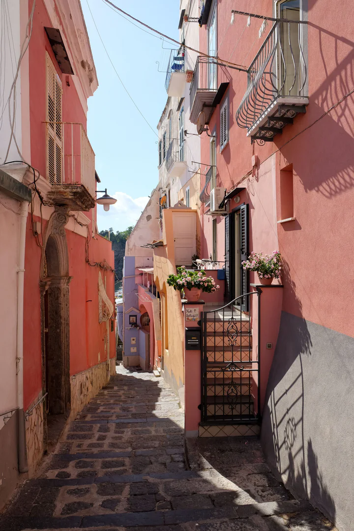 A narrow lane between pink houses