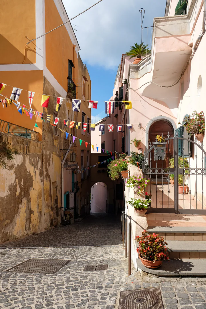 A little street with rustic cobbles, steps with flowers and nautical bunting