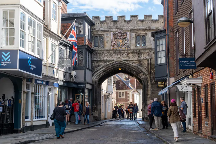 An old, ornate, arched gate over a street