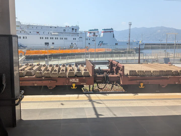 A ferry docked next to a train station
