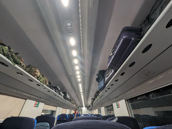 Overhead racks full of luggage