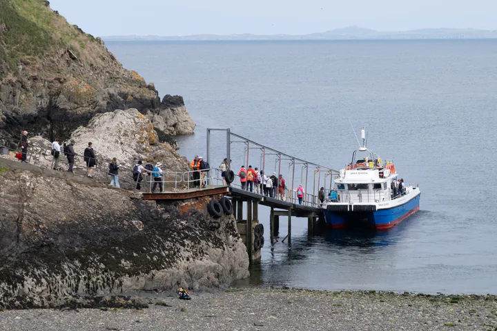 A boat at a jetty in a small basic harbour
