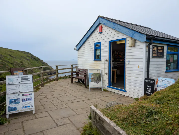 A small white building on a cliff top